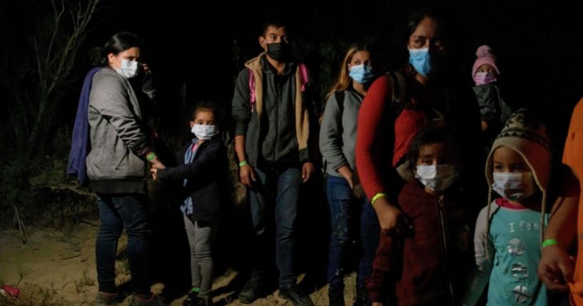 Migrants from Central America, who arrived illegally from Mexico to the U.S. to seek asylum, rest after arriving on an inflatable boat across the Rio Grande river at the border city of Roma on March 29, 2021.