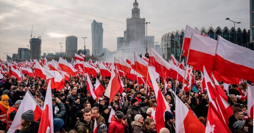 People wave national flags during a march to mark Poland's National Independence Day on Nov. 11, 2019, in Warsaw.