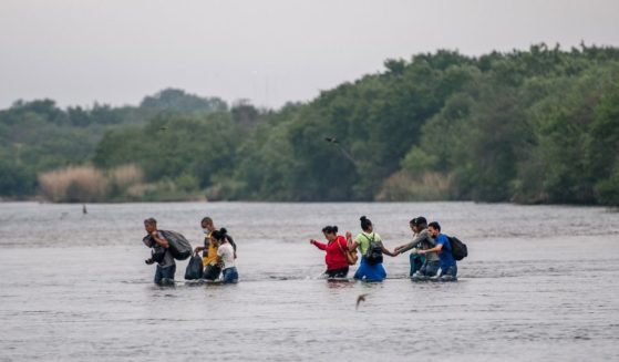 Immigrants cross the Rio Grande from Mexico into Del Rio, Texas, on Monday.