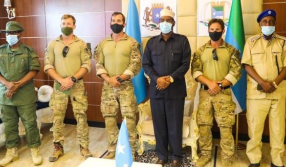 Ahmed Madobe, president of Jubaland, a federal member state within Somalia, poses with uniformed American soldiers in a photo posted on social media on May 4, 2021.