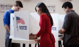 The above stock photo shows voters filling out their ballots.