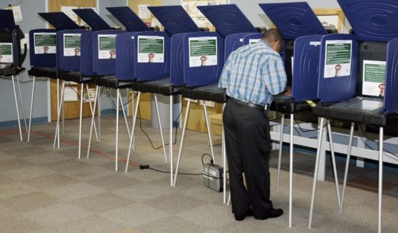 A man casts an early ballot on an electronic machine on Oct. 27, 2006, in Miami.