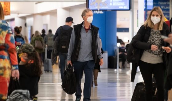 Air travelers wear face masks in Newark Liberty International Airport on Dec. 24, 2020, in New Jersey.