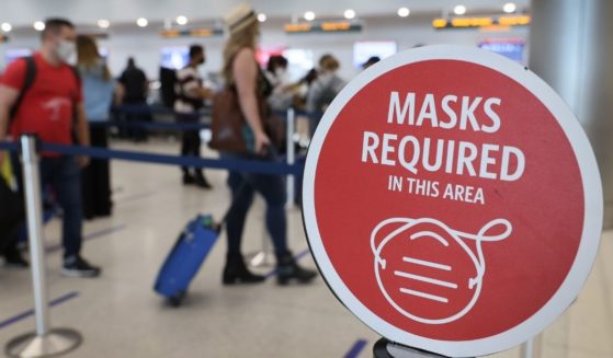 Travelers prepare to check in for their flight at Miami International Airport on Feb. 1, 2021, in Miami.