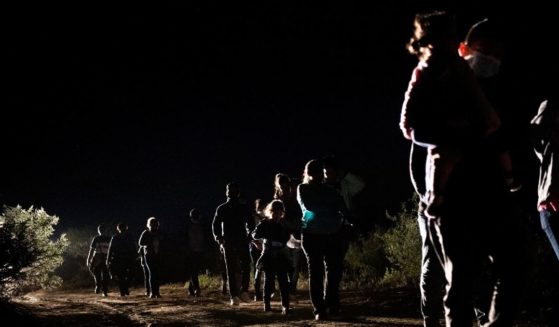 Immigrants seeking asylum walk to be processed at a border patrol processing facility after crossing the Rio Grande into the United States on Thursday in Roma, Texas.