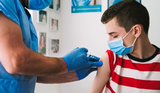 This stock photo shows a teenage boy receiving the COVID-19 vaccine from a health care worker. A Michigan 13-year-old has died after receiving his second dose of the COVID-19 vaccine.