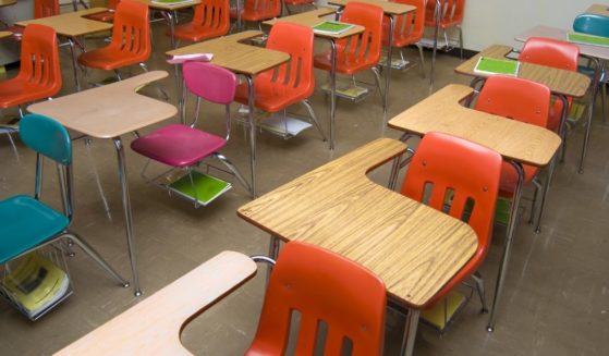 An empty school classroom is seen in the stock image above.