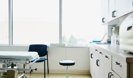 The above stock image shows an empty exam room in a hospital.