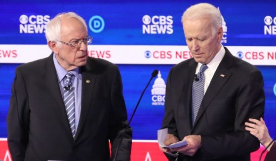 Then-presidential candidates independent Sen. Bernie Sanders of Vermont, left, and now-President Joe Biden interact at a break during the Democratic presidential primary debate at the Charleston Gaillard Center on Feb. 25, 2020, in Charleston, South Carolina.