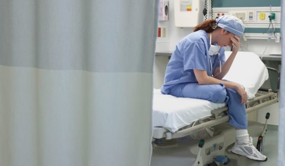 This stock photo portrays a nurse sitting in a hospital bed. The Houston Methodist Hospital is reportedly threatening employees with termination if they do not receive the COVID-19 vaccine.