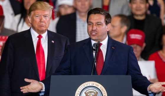 Florida Republican then-gubernatorial candidate Ron DeSantis, right, speaks with then-President Donald Trump at a campaign rally at the Pensacola International Airport on Nov. 3, 2018, in Pensacola, Florida.