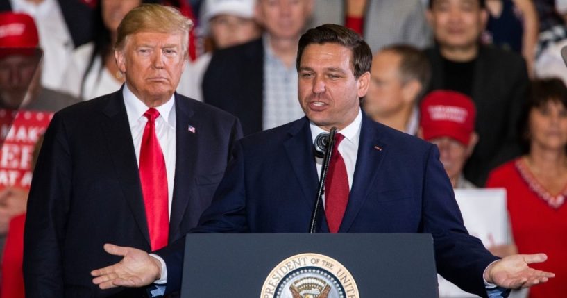 Florida Republican then-gubernatorial candidate Ron DeSantis, right, speaks with then-President Donald Trump at a campaign rally at the Pensacola International Airport on Nov. 3, 2018, in Pensacola, Florida.