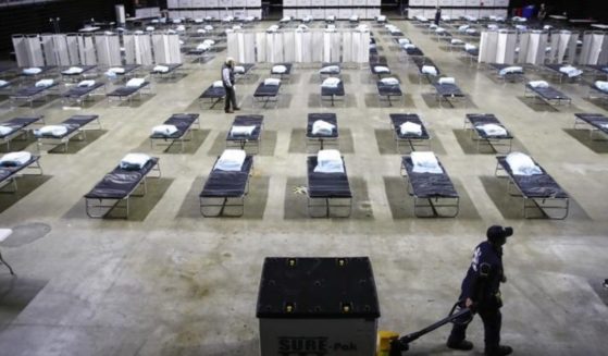 A worker moves items at a Federal Medical Station for hospital surge capacity set up at Temple University's Liacouras Center in Philadelphia on March 30, 2020.