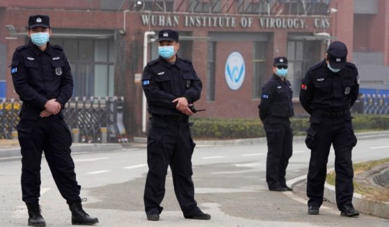 Security personnel stand guard near the entrance of the Wuhan Institute of Virology during a visit by World Health Organization inspectors in China's Hubei province on Feb. 3