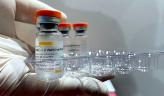 A health care worker holds a tray with the vials of the Sinovac vaccine at the COVID-19 vaccination center set up at the International Exhibition Centre in the Ukraine capital of Kyiv.