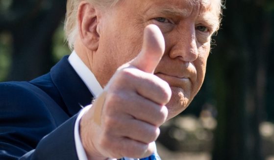 Then-President Donald Trump gives a thumbs-up as he departs the White House in Washington, DC, on Oct. 15, 2020.