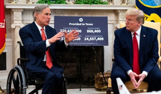 Then-President Donald Trump, right, speaks to reporters while hosting Texas Gov. Greg Abbott in the Oval Office at the White House on May 7, 2020, in Washington, D.C.