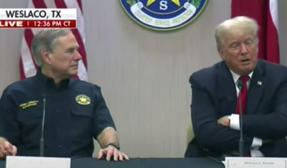 Texas Republican Gov. Greg Abbott (L) and former President Donald Trump (R) at a border security session near the U.S.-Mexican border on June 30.