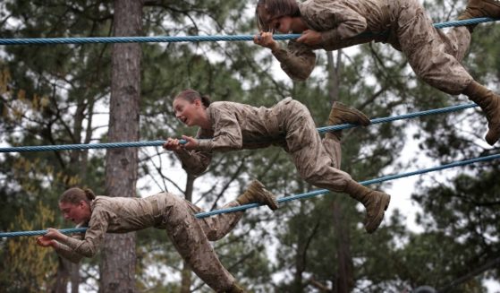 Female Marine recruits navigate an obstacle course during boot camp on Feb. 27, 2013, in Parris Island, South Carolina.