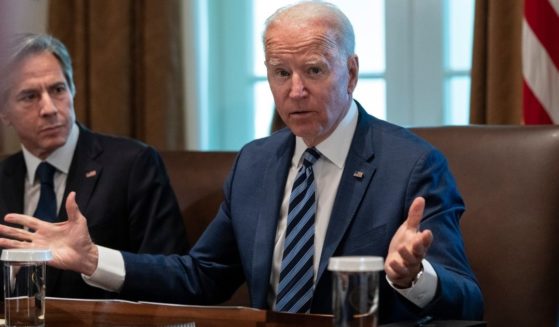 President Joe Biden speaks while Secretary of State Antony Blinken looks on at the start of a Cabinet meeting in the Cabinet Room of the White House in Washington on Tuesday.