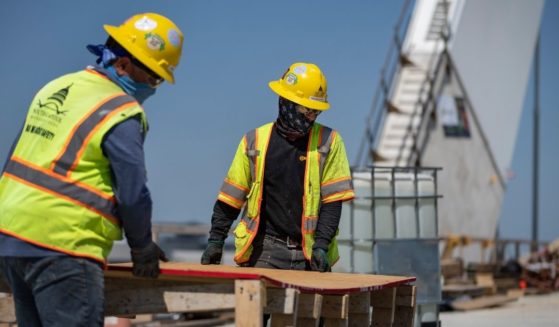 Construction workers work on the new Frederick Douglass Memorial Bridge on May 19, 2021, in Washington, D.C.