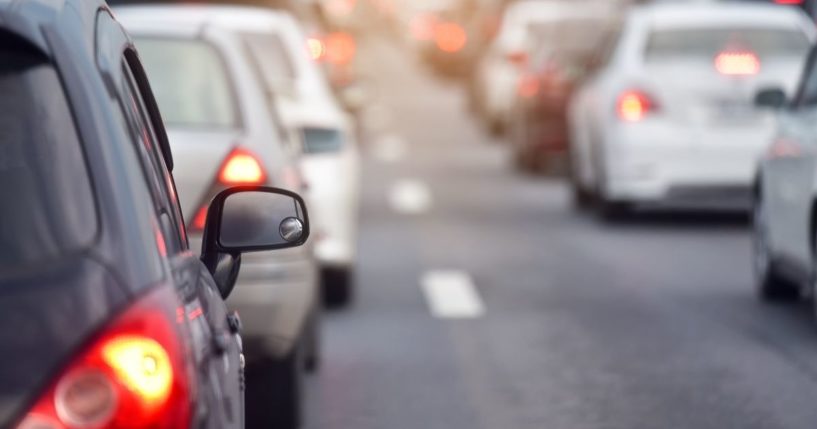 This stock photo portrays cars driving on a busy road. The FBI is reportedly now using built-in WiFi hotspots in cars to track people.