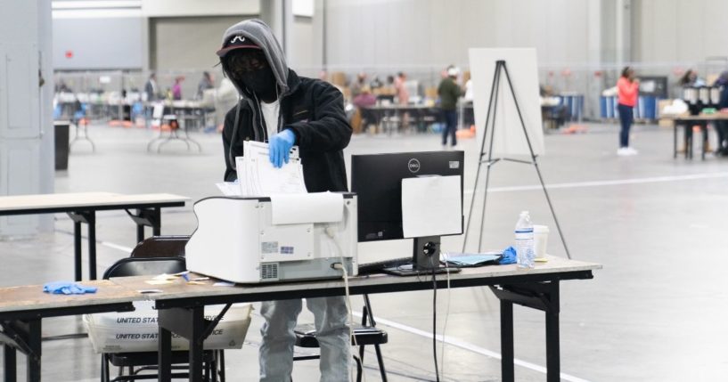 Election officials count votes for Fulton County on Jan. 6, 2021, in Atlanta.