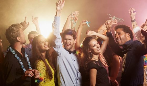 This stock photo portrays a group of friends dancing to music. Greece announced Saturday that music will be banned around the clock until the end of the month on the popular tourist island of Mykonos in response to an increase in COVID cases.