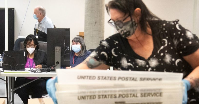 Ballots are counted by Maricopa County Elections Department staff on Oct. 31, 2020, in Phoenix.