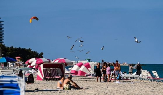 People relax on the beach in Miami Beach, Florida, on March 23.