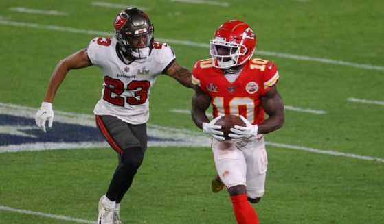 Tyreek Hill, right, of the Kansas City Chiefs rushes ahead of Sean Murphy-Bunting of the Tampa Bay Buccaneers during the third quarter of the game in Super Bowl LV at Raymond James Stadium on Feb. 7, 2021, in Tampa, Florida.