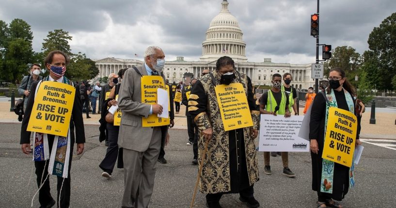 Leftist activists including the Rev. Dr. William Barber, center, pray on Capitol Hill on Sept. 29, 2020, in Washington, D.C.