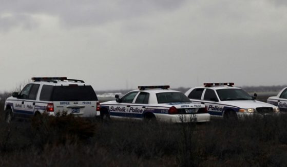 Suffolk County Police cars involved in a search effort are parked on the side of the road along a stretch of beach highway on April 5, 2011, in Babylon, New York.