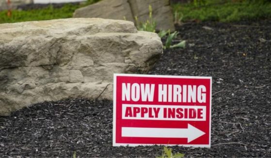 Hiring signs are posted outside a gas station in Cranberry Township, Pennsylvania, on May 5, 2021.