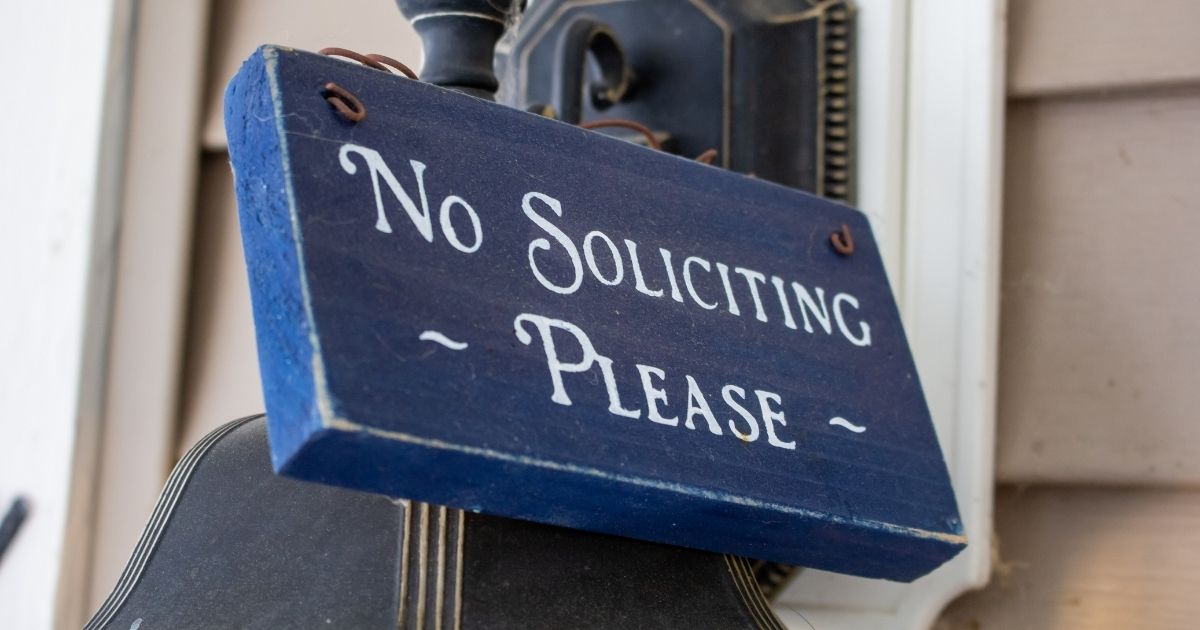 A "no soliciting, please" sign.