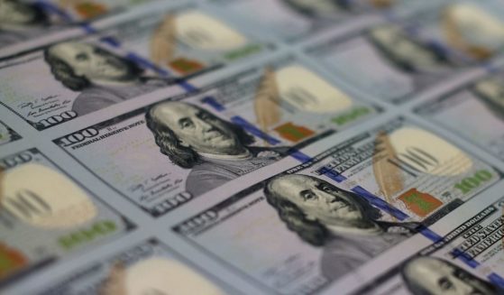 A stack of $100 bills held at the Bureau of Engraving and Printing in Washington, D.C., is seen in this May 20, 2013, photo.