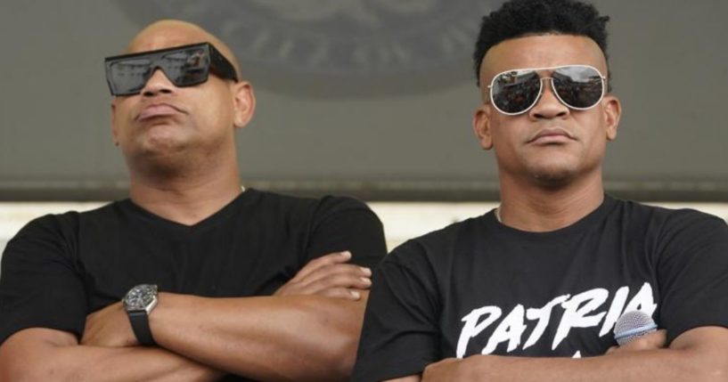 Cuban reggaeton musicians Alexander Delgado, left, and Randy Malcom, both with the band Gente de Zona, look out into a crowd of demonstrators, Wednesday in Miami's Little Havana neighborhood, as people rallied in support of anti-government demonstrations in Cuba. Gente de Zona's song "Patria y Vida," which means Homeland and Life, has become the anthem of the demonstrations and is a play on the phrase "Patria o Muerte," Homeland or death, which was a phrase in the Cuban Revolution.