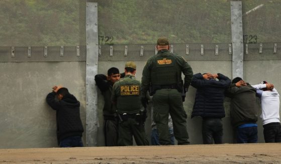 Men surrender to U.S. Border Patrol agents after jumping a fence in an attempt to get into the United States from Tijuana, Mexico, on Jan. 17, 2019.