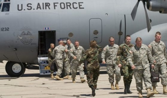 Members of the Kentucky National Guard 206th Engineer battalion arrive by C-130 Hercules transport plane on July 11, 2006, in Tucson, Arizona.