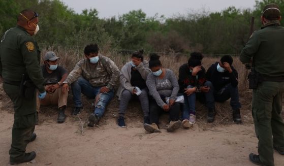 U.S. Border Patrol agents process a group of people they caught crossing the border from Mexico on March 27, in Penitas, Texas.