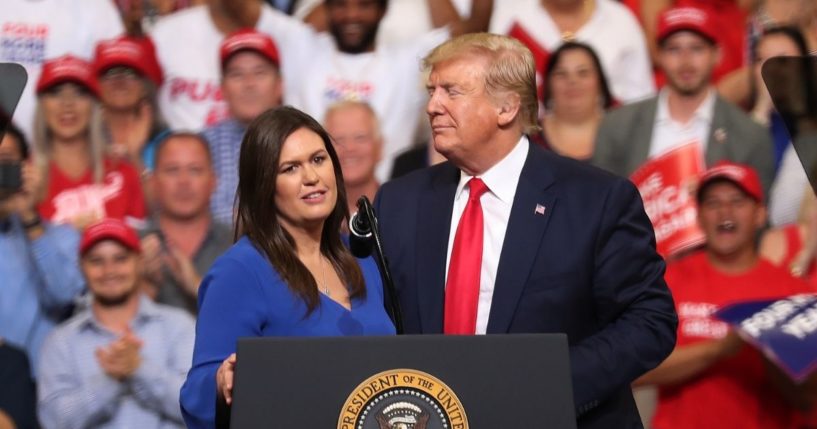 Then-President Donald Trump stands with Sarah Huckabee Sanders at the Amway Center on June 18, 2019, in Orlando, Florida.