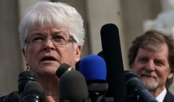 Floral artist Barronelle Stutzman, left, speaks to members of the media in front of the U.S. Supreme Court as cake artist Jack Phillips, right, looks on Dec. 5, 2017, in Washington, D.C.
