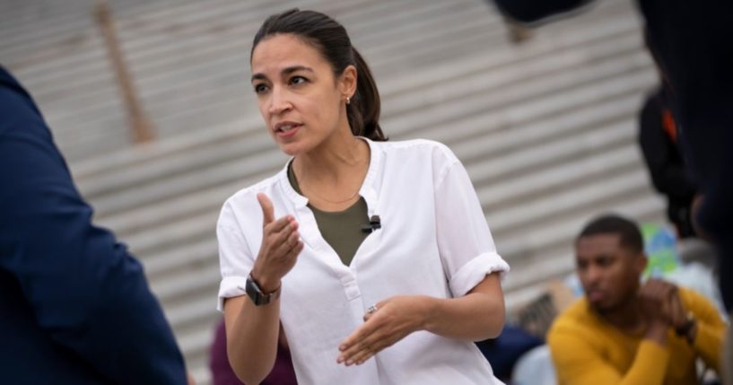 Rep. Alexandria Ocasio-Cortez talks with a reporter on the steps of the U.S. Capitol on Aug. 3, 2021, in Washington, D.C.