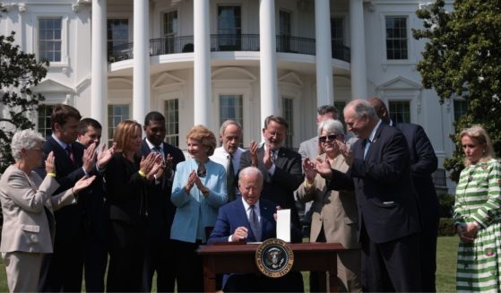 Auto industry executives and representatives applaud after President Joe Biden signs an executive order on electric vehicles on the South Lawn of the White House in Washington on Aug. 5.