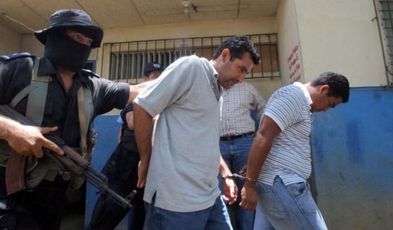 Two alleged members of the Mexican Sinaloa Cartel are escorted by Nicaraguan policemen on April 16, 2007.