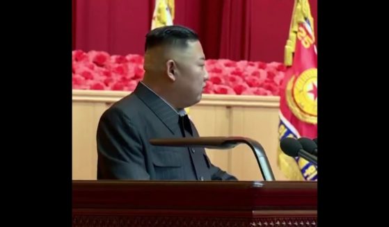 North Korea Supreme Leader Kim Jong Un is seen speaking at a late July event, with a bandage on the back of his head.