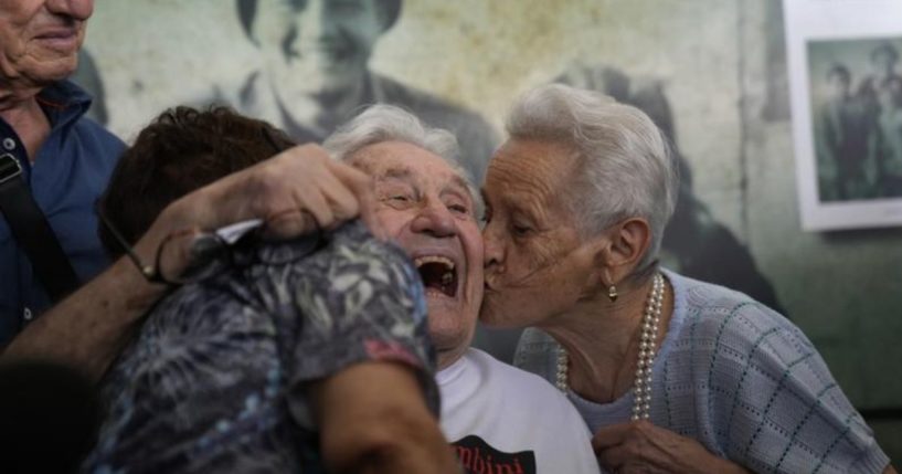 Retired soldier Martin Adler is seen meeting with the children he saved during WWII at Bologna’s airport in Italy on Monday.