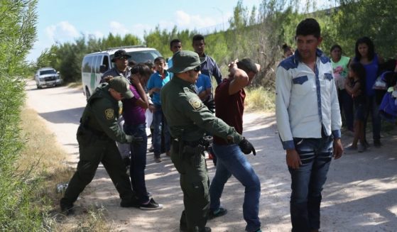 Border Patrol agents take a group of Central American asylum seekers into custody on June 12, 2018, near McAllen, Texas.