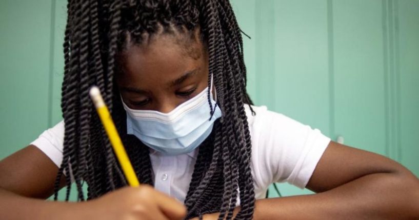 Sixth-grade student Adriana Campbell is seen wearing a mask while writing at Freeman Elementary School in Flint, Michigan in a photo taken on Wednesday.