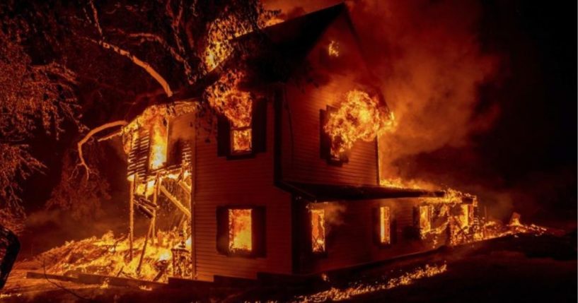 A home on Jeters Road in Janesville, California, is seen burning on Monday.